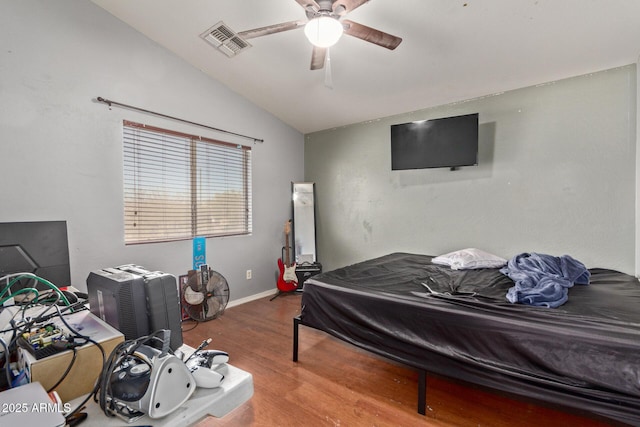 bedroom with vaulted ceiling, ceiling fan, and hardwood / wood-style floors