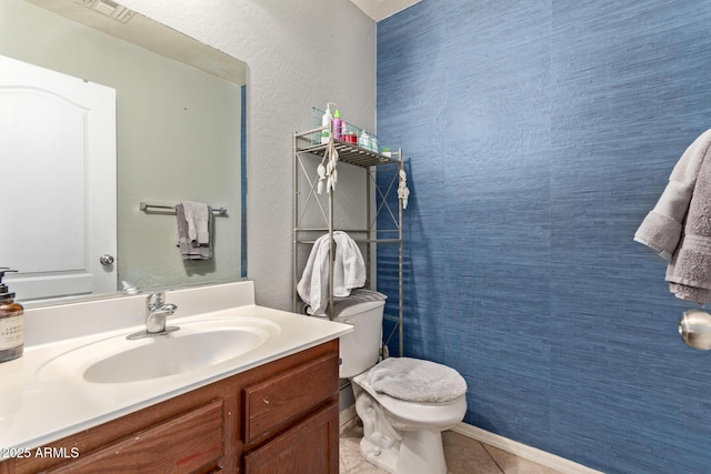 bathroom featuring vanity, tile patterned floors, and toilet