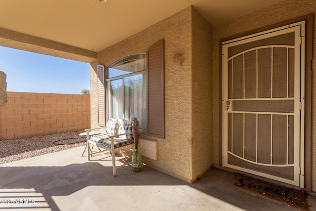 view of exterior entry featuring a patio