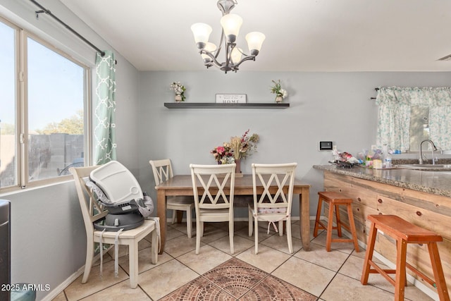 tiled dining space with sink and an inviting chandelier