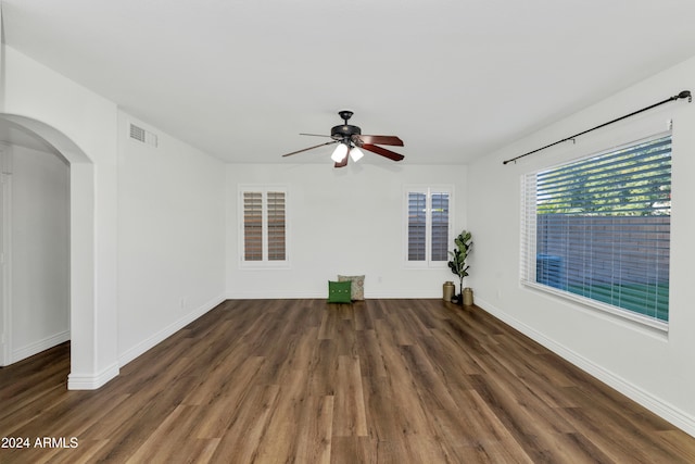 unfurnished room featuring dark hardwood / wood-style floors and ceiling fan