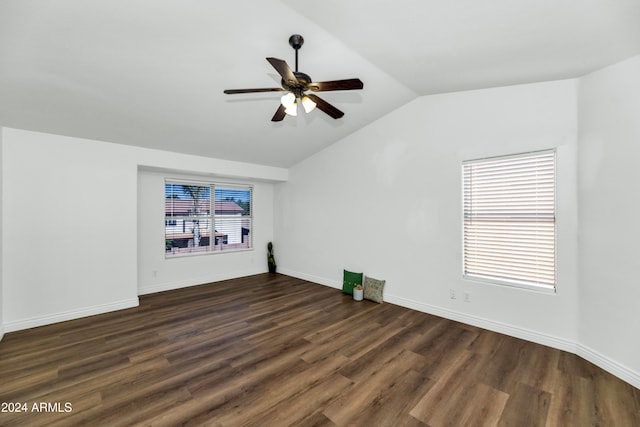 unfurnished living room with ceiling fan, dark wood-type flooring, and vaulted ceiling