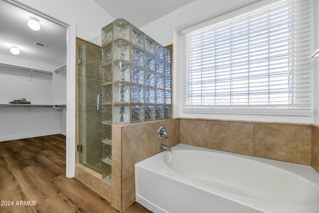 bathroom with separate shower and tub and hardwood / wood-style floors