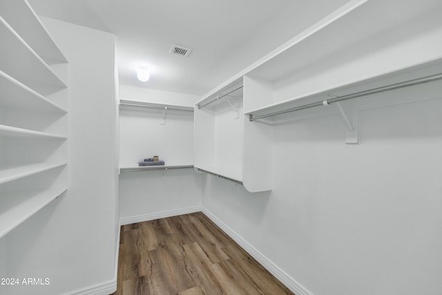 spacious closet with hardwood / wood-style floors