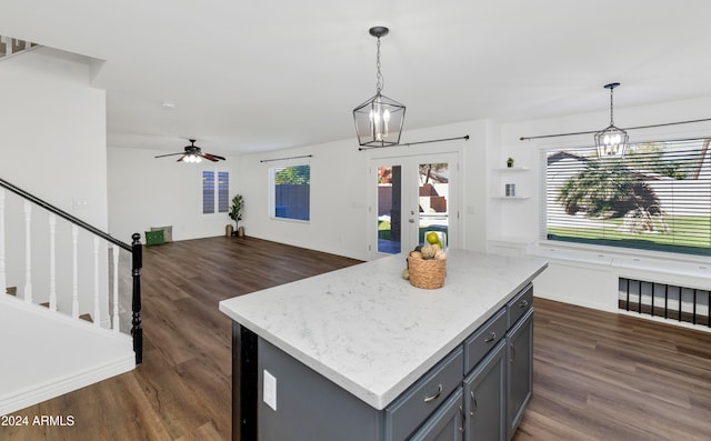 kitchen featuring decorative light fixtures, a kitchen island, and dark hardwood / wood-style floors