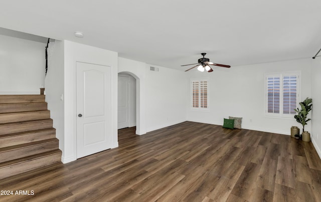 unfurnished living room with ceiling fan and dark hardwood / wood-style flooring