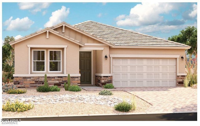 view of front facade featuring a garage, stone siding, decorative driveway, and stucco siding