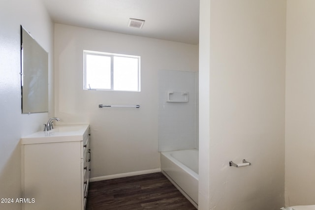 bathroom featuring vanity, shower / washtub combination, and hardwood / wood-style flooring