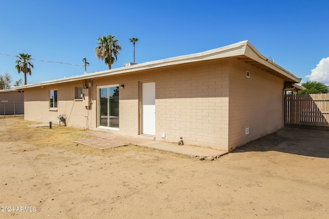 back of property with a patio