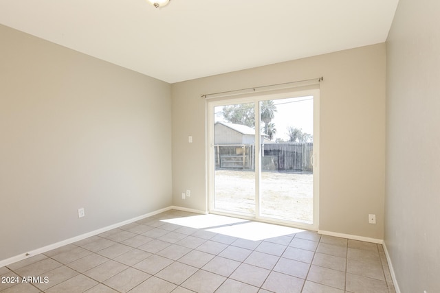 spare room featuring light tile patterned flooring