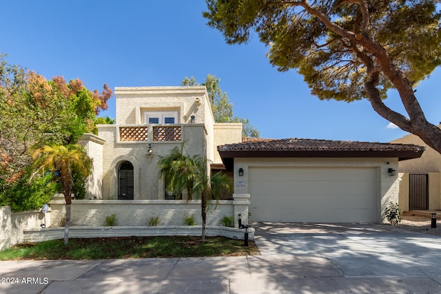 mediterranean / spanish-style house with a garage