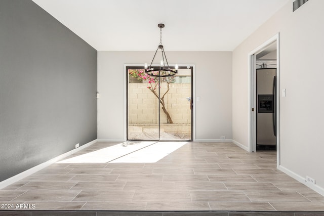 unfurnished dining area with an inviting chandelier