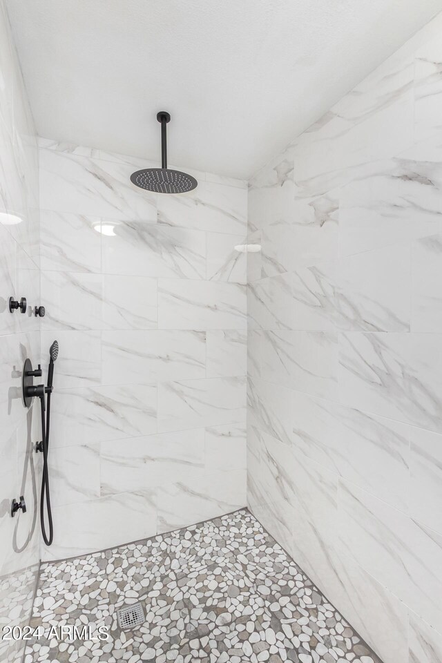 bathroom featuring double vanity and a shower