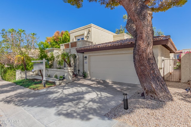 mediterranean / spanish-style house with a garage