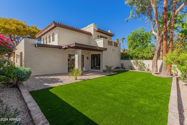 rear view of house with a yard