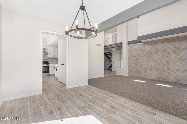 unfurnished living room with light colored carpet, a healthy amount of sunlight, a high ceiling, and ceiling fan