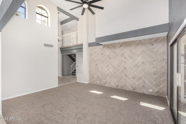 kitchen with light wood-type flooring, electric range, wall chimney exhaust hood, tasteful backsplash, and white cabinetry