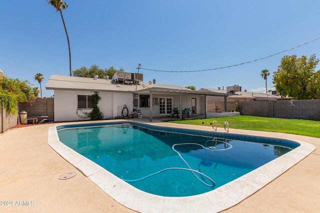 view of swimming pool with a patio and a yard