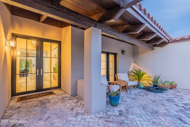 entrance to property with french doors and a patio