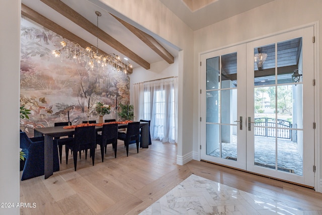 dining room featuring lofted ceiling with beams, french doors, an inviting chandelier, and light hardwood / wood-style flooring