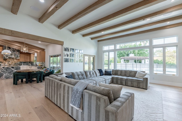 living room featuring beamed ceiling and light hardwood / wood-style flooring