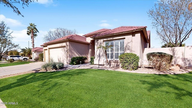 mediterranean / spanish house with a garage and a front yard