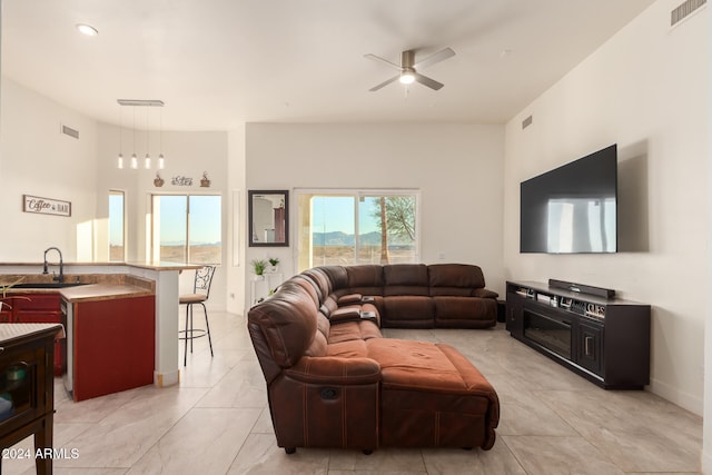 living room featuring ceiling fan and sink