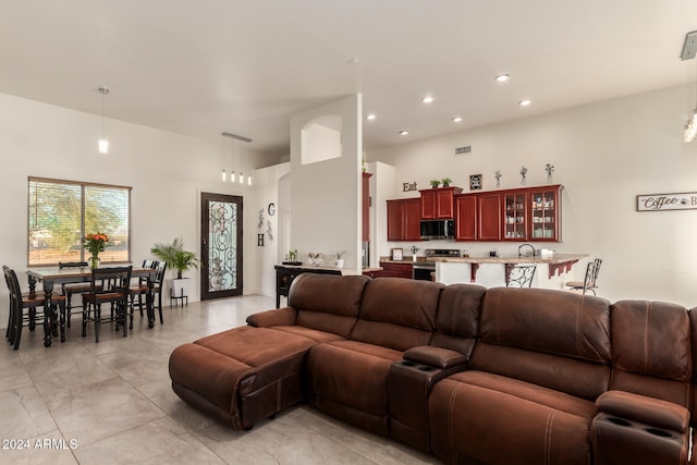 living room with a high ceiling and sink