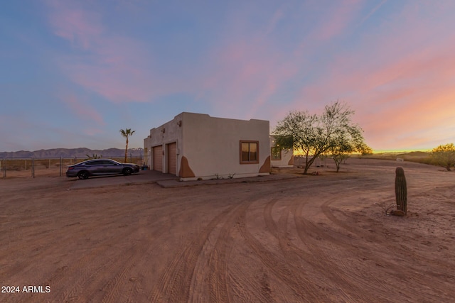 pueblo-style home featuring a mountain view and a garage