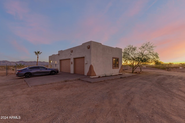 view of front of home with a mountain view and a garage