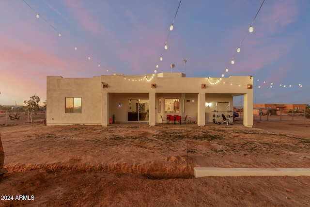 view of back house at dusk