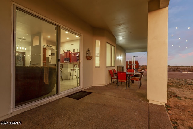 view of patio terrace at dusk