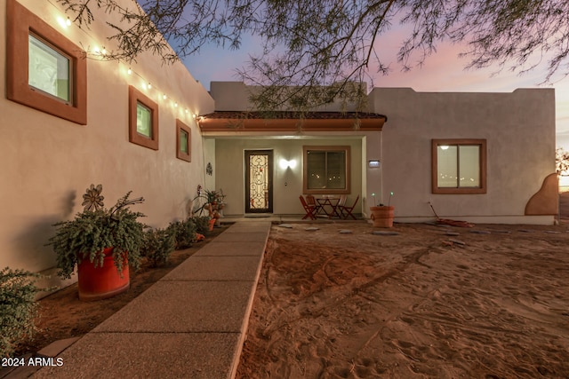 view of exterior entry at dusk