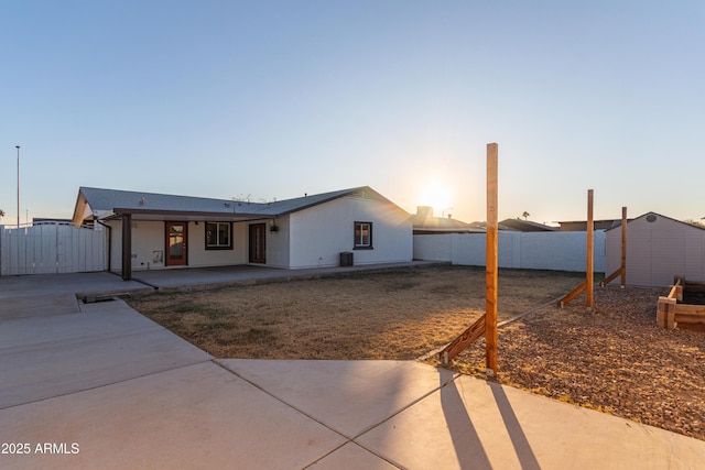 view of front of home featuring a storage unit and a patio area