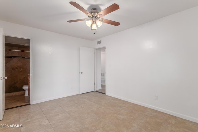 unfurnished bedroom featuring ceiling fan and ensuite bath