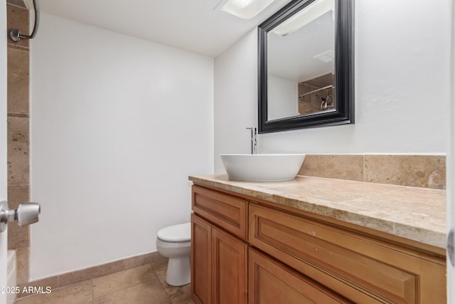 bathroom with tile patterned floors, vanity, and toilet