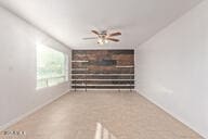 unfurnished living room featuring ceiling fan