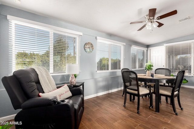 dining area with dark wood-type flooring, ceiling fan, and vaulted ceiling