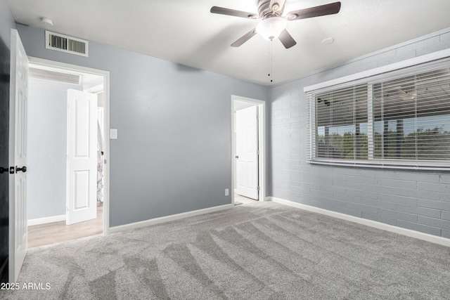 spare room featuring light carpet and ceiling fan