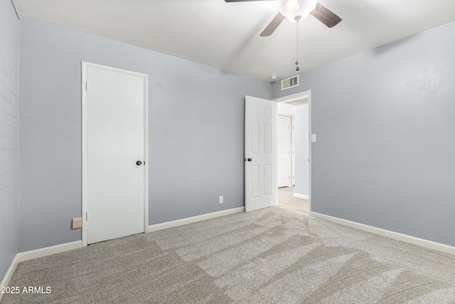 spare room with light carpet and ceiling fan