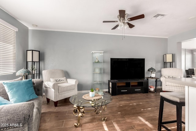 living room featuring crown molding and ceiling fan