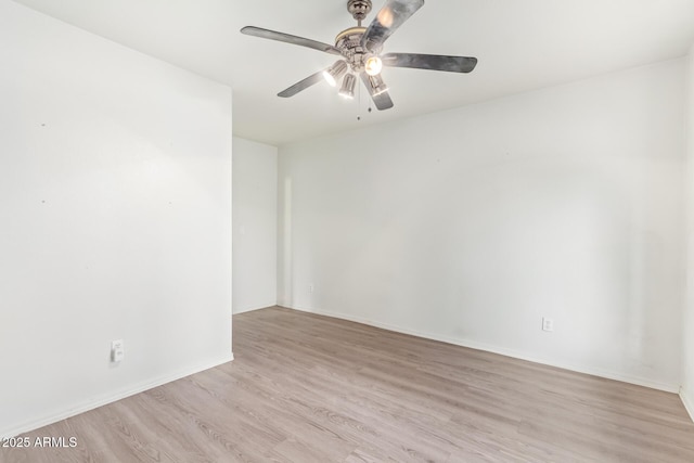 spare room with light hardwood / wood-style flooring and ceiling fan