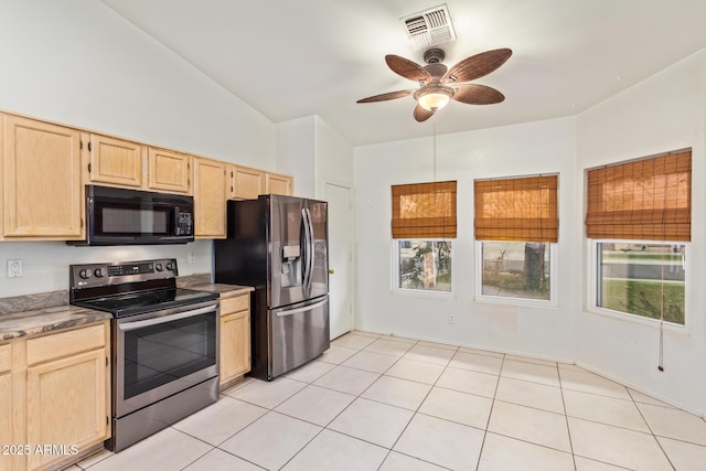 kitchen with lofted ceiling, light brown cabinetry, light tile patterned floors, appliances with stainless steel finishes, and ceiling fan