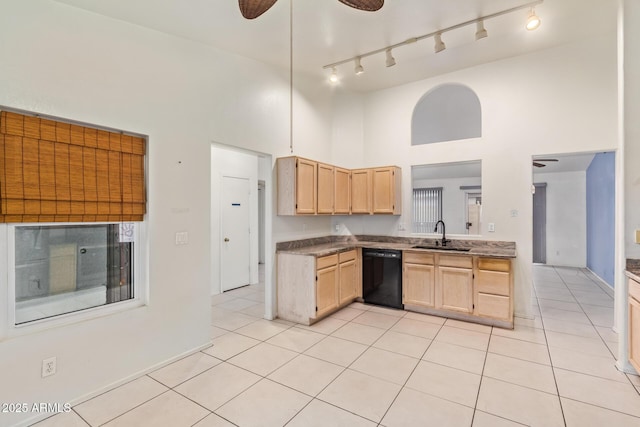 kitchen featuring light tile patterned flooring, sink, light brown cabinets, dishwasher, and a high ceiling