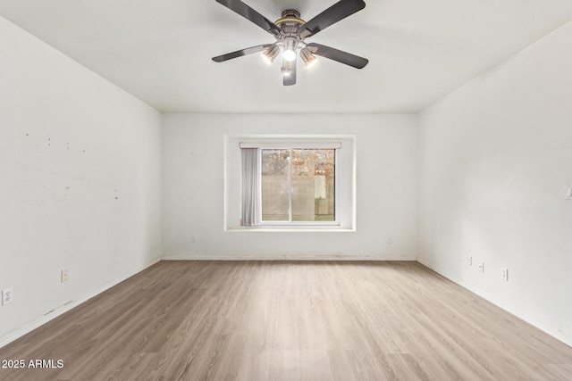 spare room featuring light hardwood / wood-style flooring and ceiling fan