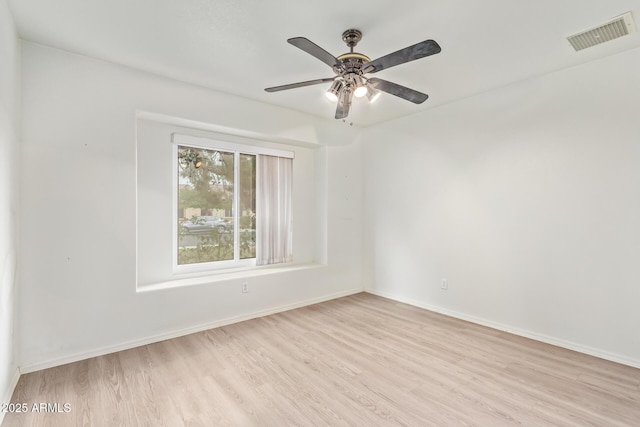 spare room with ceiling fan and light wood-type flooring