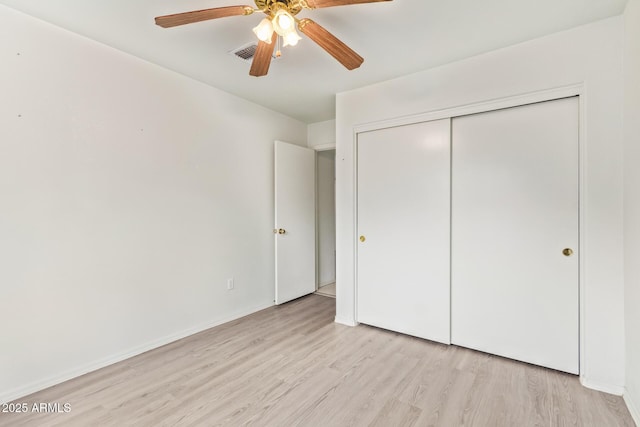 unfurnished bedroom featuring a closet, ceiling fan, and light wood-type flooring