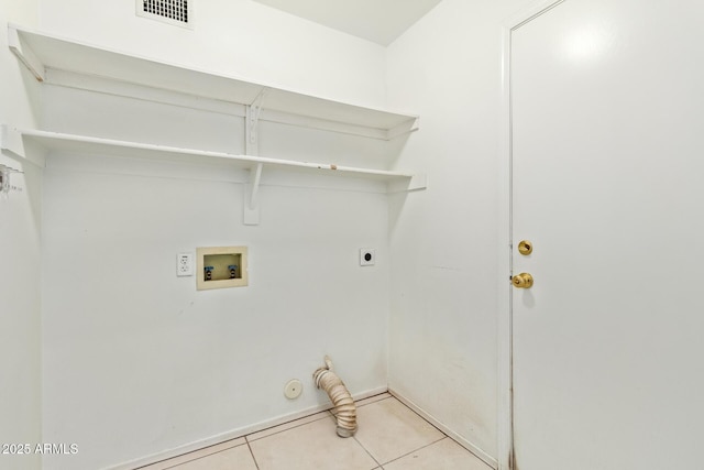 clothes washing area featuring electric dryer hookup, hookup for a gas dryer, hookup for a washing machine, and light tile patterned flooring