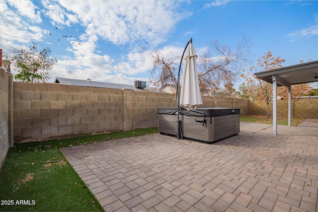 view of patio / terrace with a hot tub