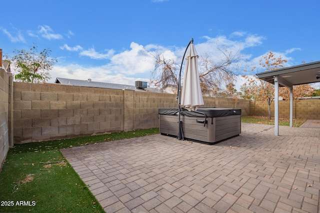 view of patio / terrace with a hot tub